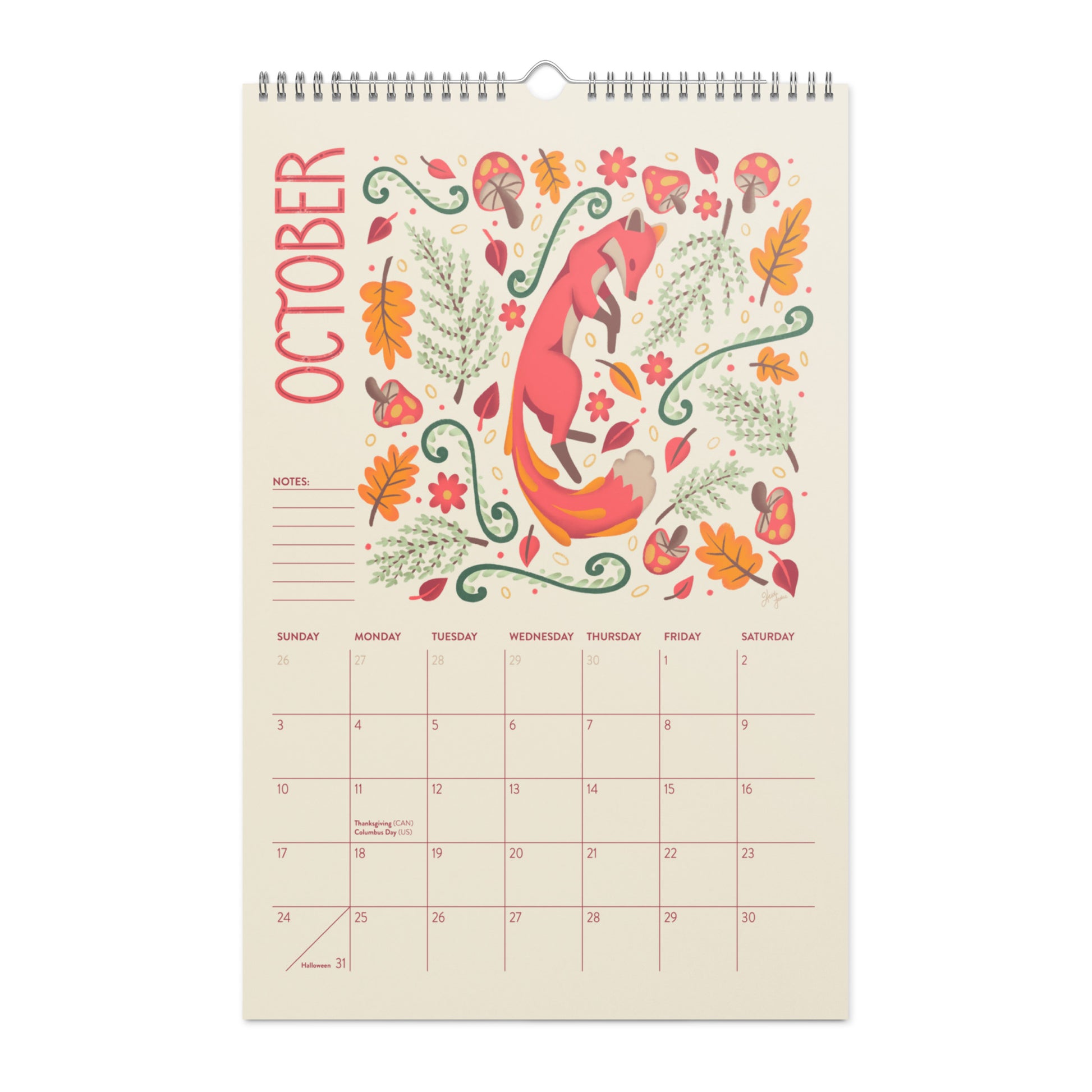 A spiral-bound October wall calendar page with a whimsical autumn fox illustration in orange, red, green, and yellow on a cream background, plus a Sunday through Saturday calendar grid below. 2027 wire-bound wall calendar hanging on a neutral wall, displaying colourful folk-art animal artwork and a clear monthly layout. Ideal for home offices, kitchens, studios, classrooms, or anyone looking for a decorative illustrated 2027 wall calendar with unique art