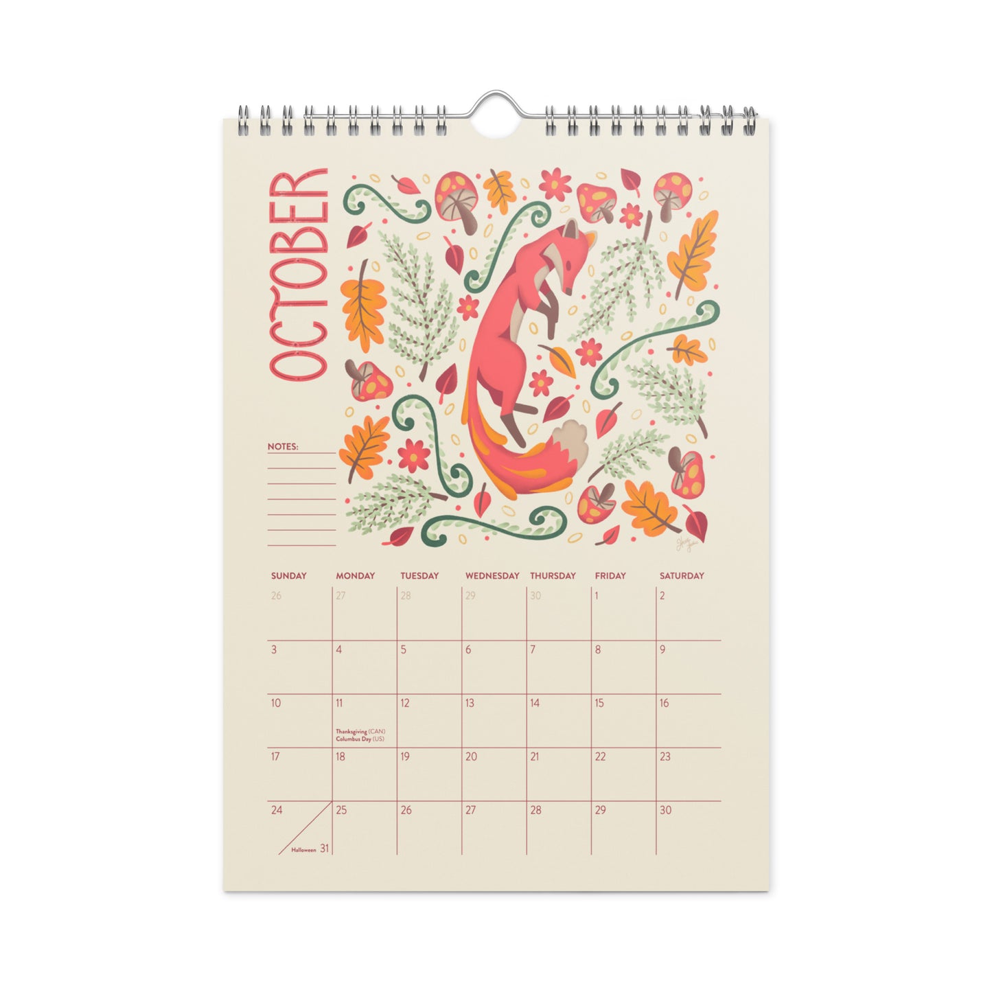A spiral-bound October wall calendar page with a whimsical fox illustration surrounded by autumn leaves, flowers, and foliage on a cream background. 2027 wire-bound wall calendar hanging on a neutral wall, displaying colourful folk-art animal artwork and a clear monthly layout. Ideal for home offices, kitchens, studios, classrooms, or anyone looking for a decorative illustrated 2027 wall calendar with unique art
