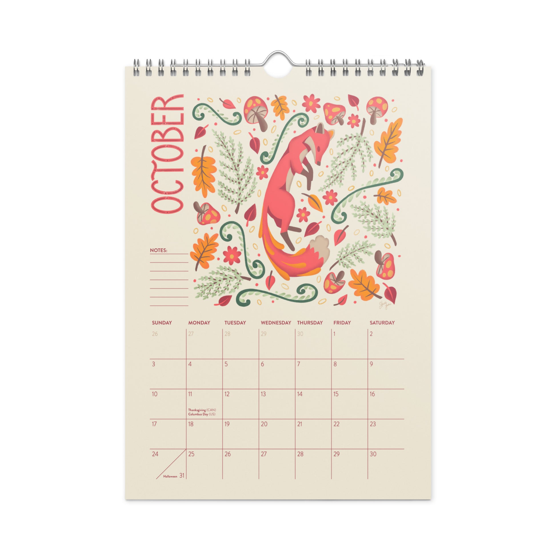 A spiral-bound October wall calendar page with a whimsical fox illustration surrounded by autumn leaves, flowers, and foliage on a cream background. 2027 wire-bound wall calendar hanging on a neutral wall, displaying colourful folk-art animal artwork and a clear monthly layout. Ideal for home offices, kitchens, studios, classrooms, or anyone looking for a decorative illustrated 2027 wall calendar with unique art