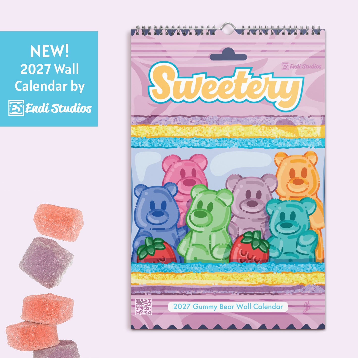 A spiral-bound 2027 wall calendar titled 'Sweetery' featuring colorful gummy bear illustrations, shown on a pale pink background with a blue promotional badge and loose gummy candies beside it.