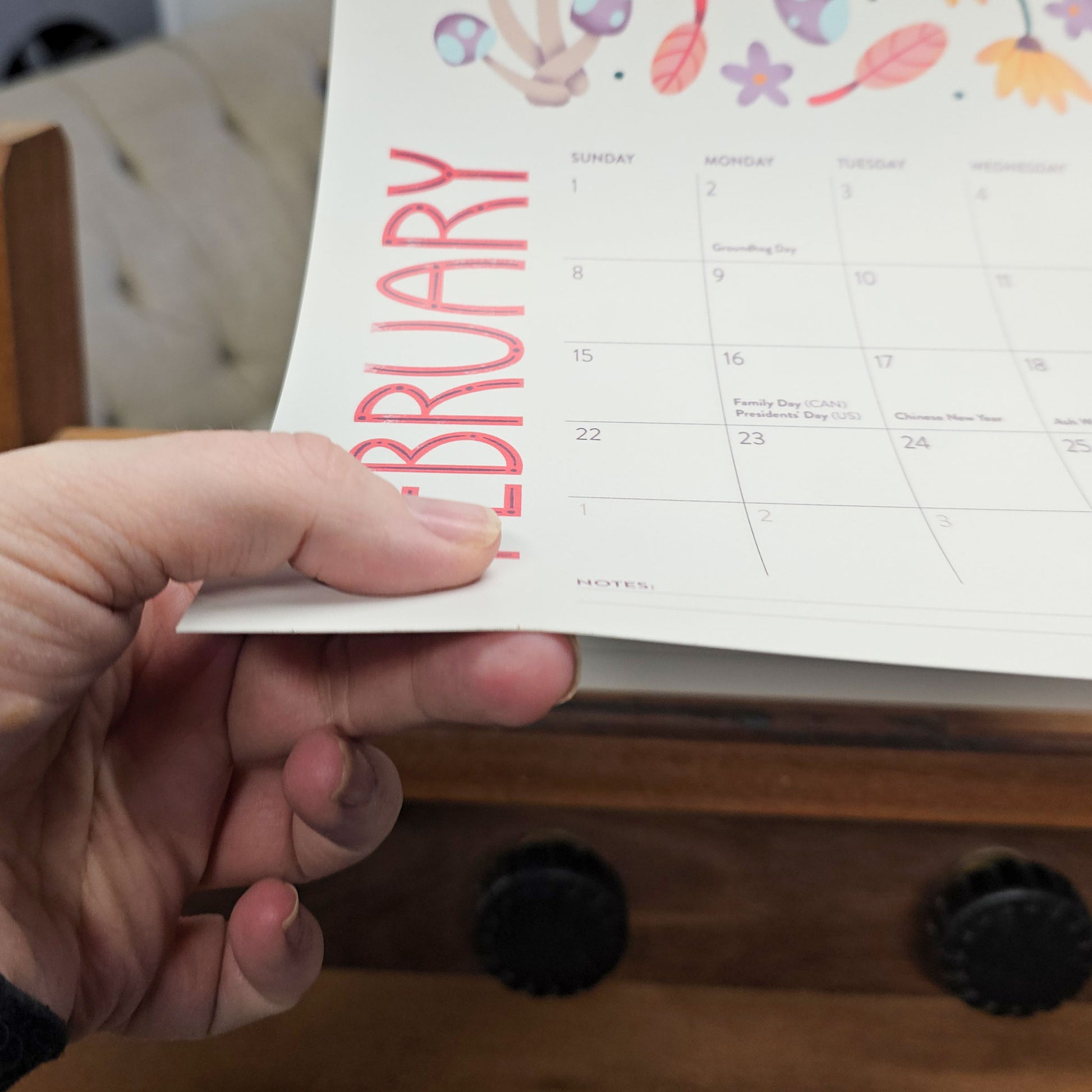 Close up of the paper used in a 2027 wall calendar featuring colourful folk-art animal illustrations. Wire-bound with premium thick paper, this illustrated monthly calendar showcases vibrant artwork for each month. Ideal for shoppers looking for a 2027 calendar, animal art calendar, home décor calendar, or unique artist-designed wall calendar.