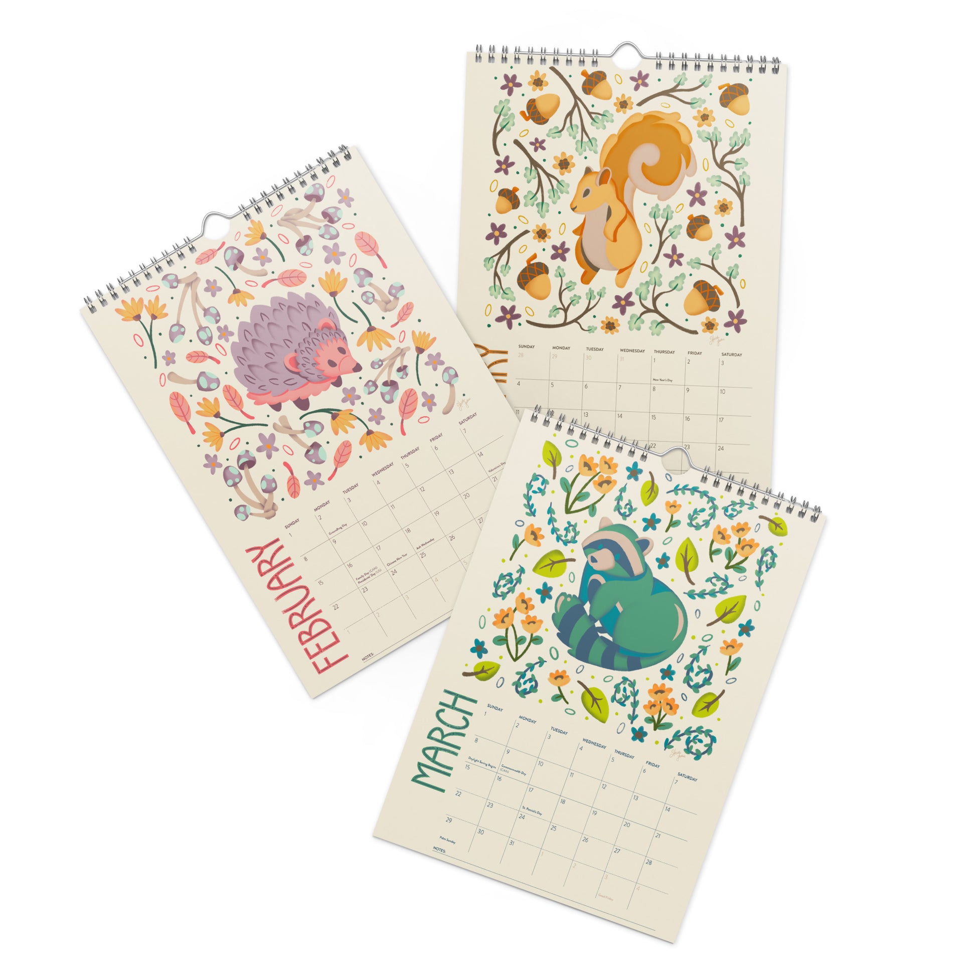 A 2026 wall calendar featuring colourful folk-art animal illustrations displayed in a flat lay. Wire-bound with premium thick paper, this illustrated monthly calendar showcases vibrant artwork for each month. Ideal for shoppers looking for a 2026 calendar, animal art calendar, home décor calendar, or unique artist-designed wall calendar.